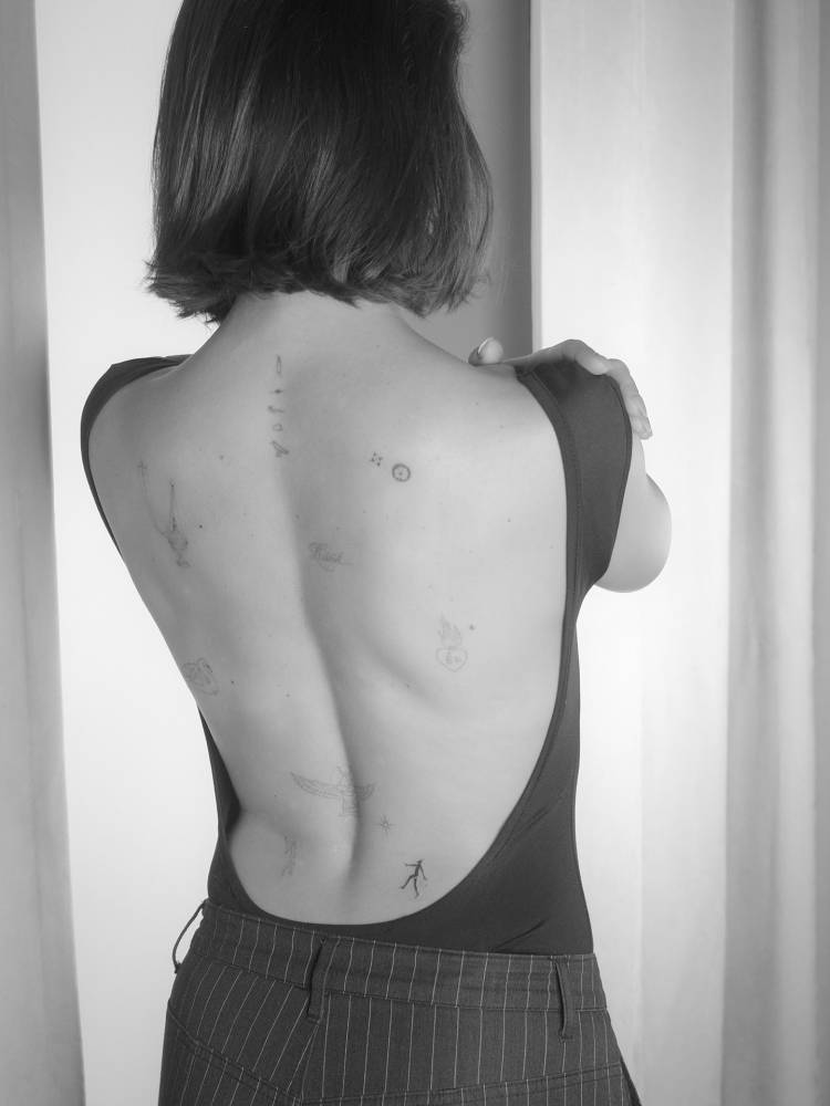 Back composition tattoos done in fine line style.