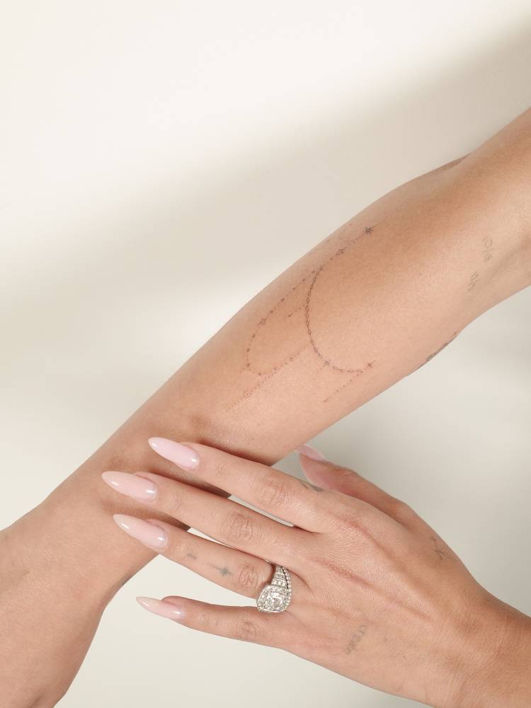 Ornamental design tattooed on the forearm, done in fine line style.