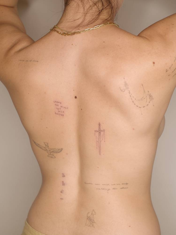 Fine line style back composition tattoos.
