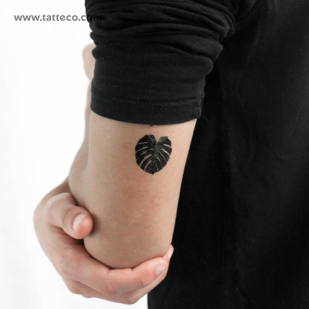 Monstera leaf temporary tattoo in micro-realistic style.