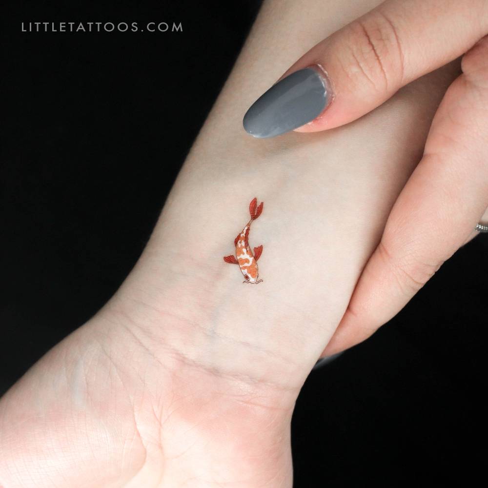 Illustrative style koi fish temporary tattoo located on the wrist.