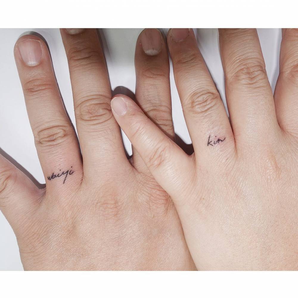 Matching names tattoo in handwritten font for couple.