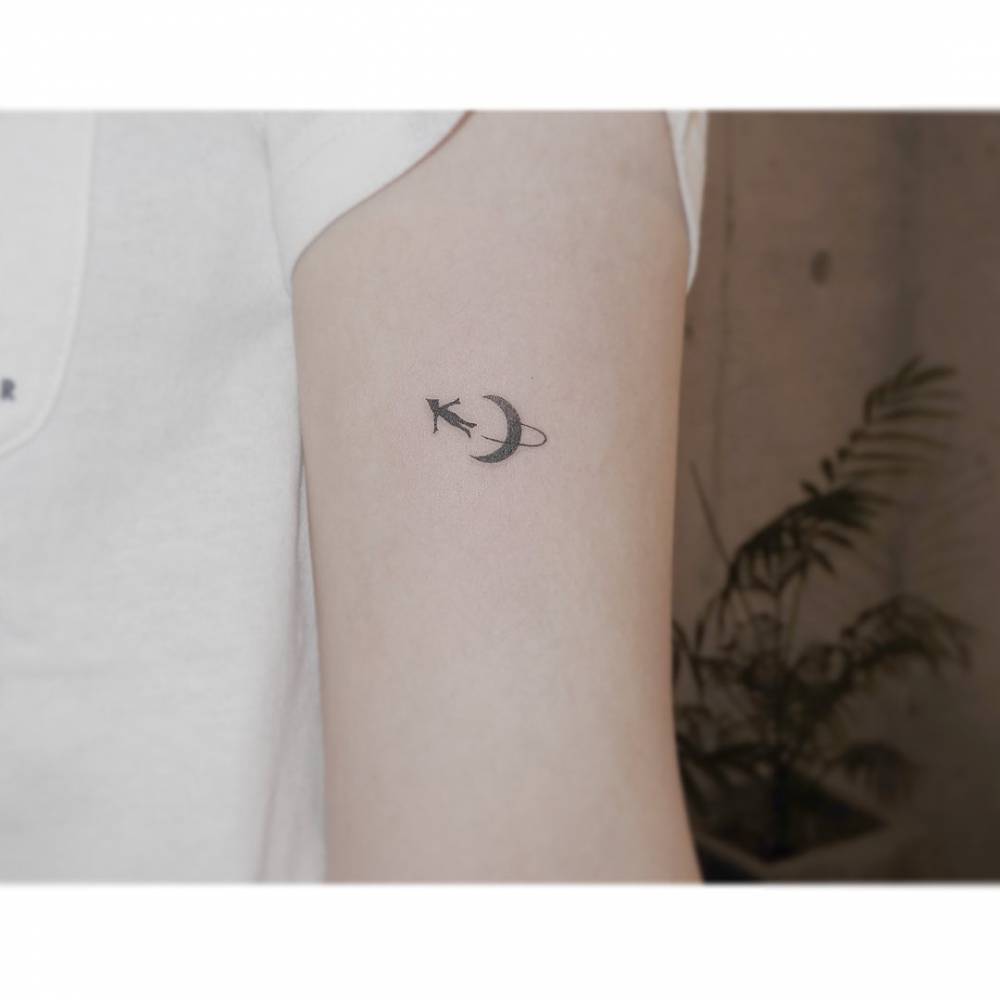 Peter Pan and crescent moon tattoo located on the bicep.