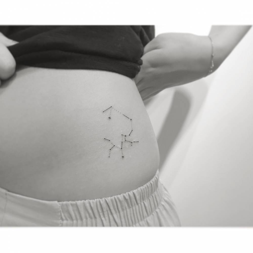 Sagittarius constellation tattoo located on the hip.