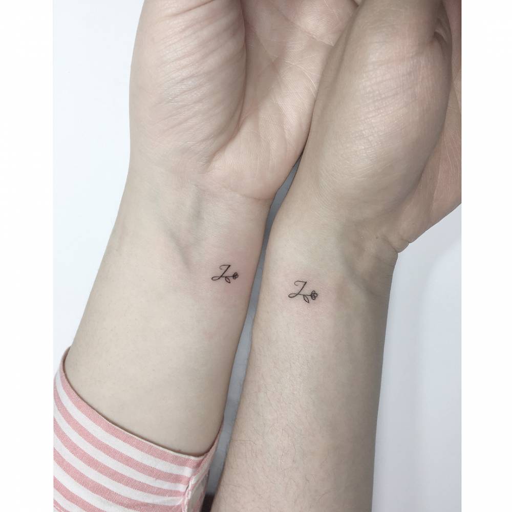 Matching letter "J" and flower tattoo for best friends.