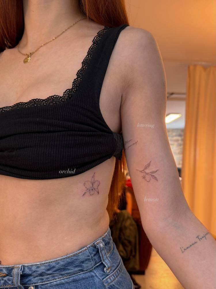 Orchid and lemon tattoos in fine line style.