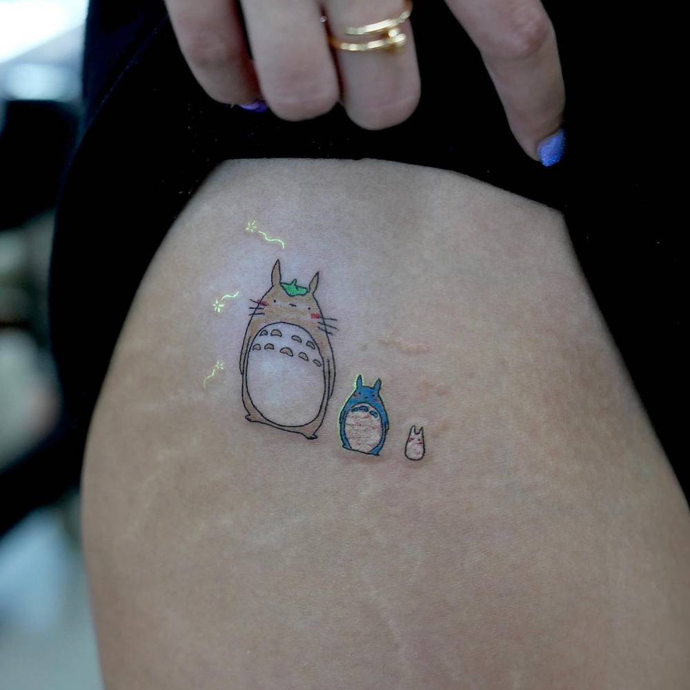 Totoro tattoo in cartoon style placed on the hip.