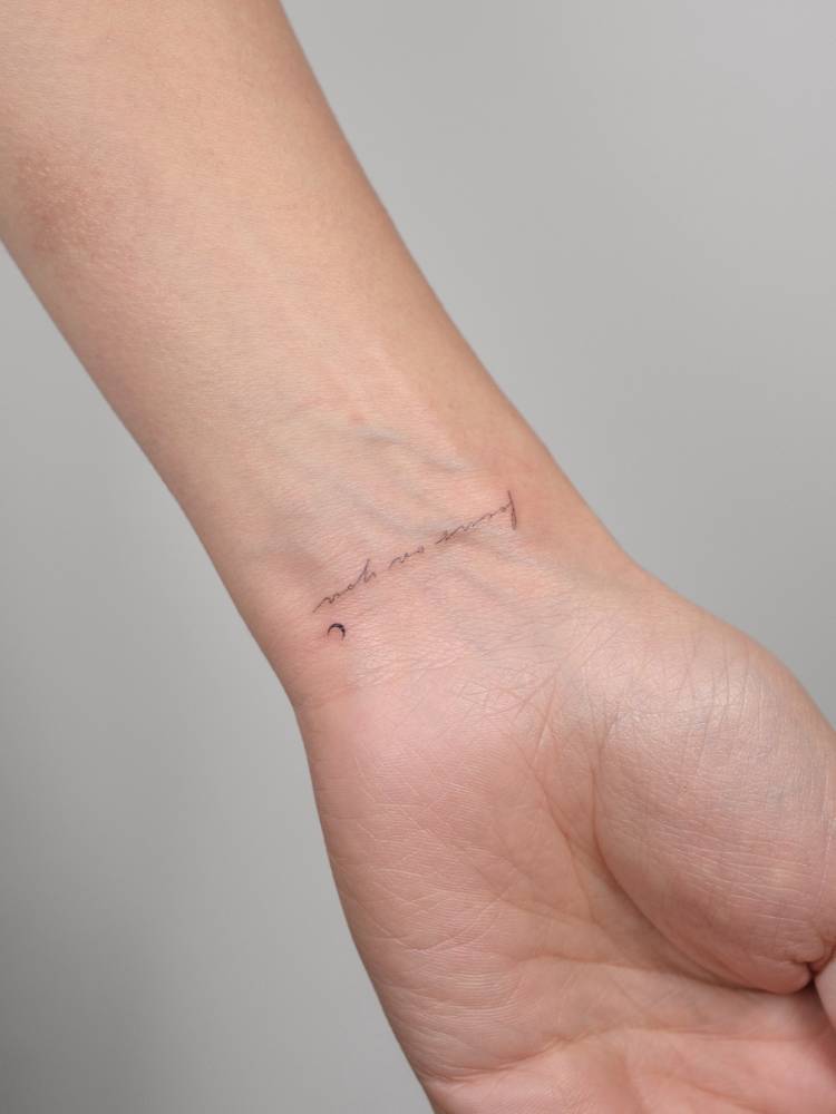 "Focus on you" lettering tattoo located on the wrist.