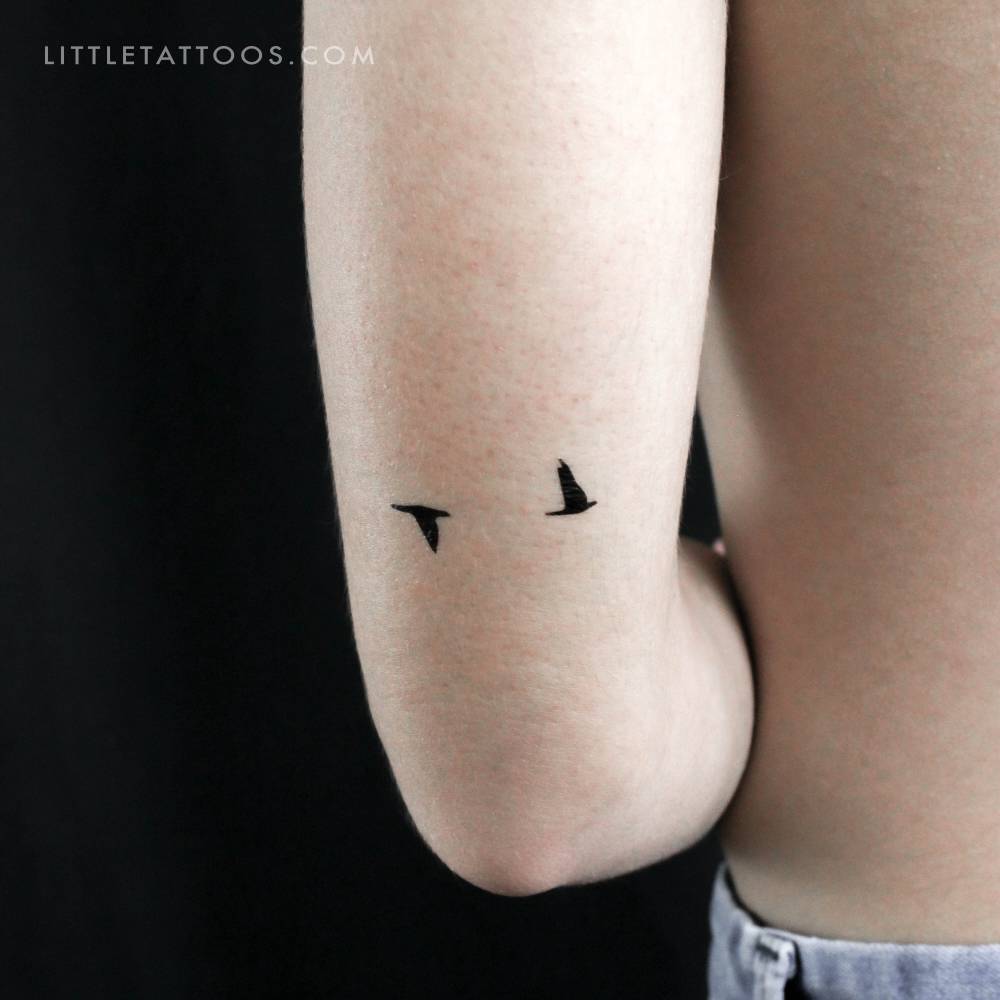 Flying bird couple temporary tattoo placed on the tricep.