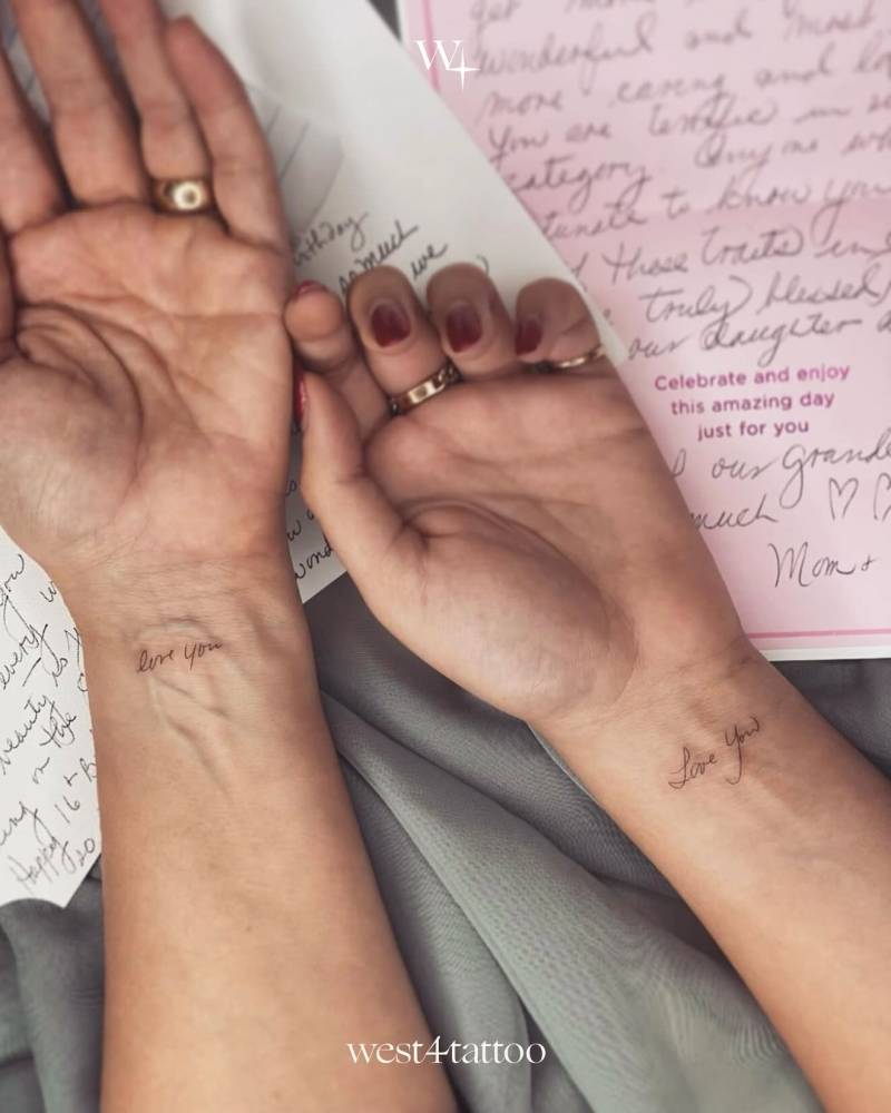 "Love you" matching lettering tattoo for couple.