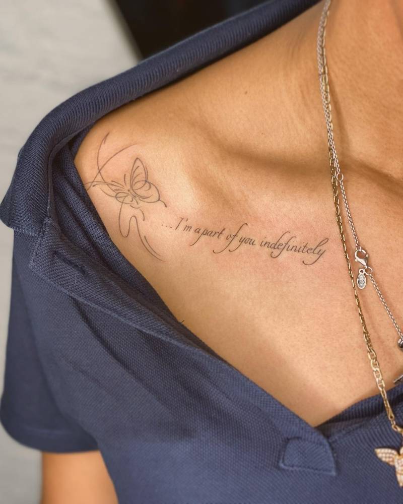 "I'm a part of you indefinitely" and butterfly tattoo located on the collarbone.