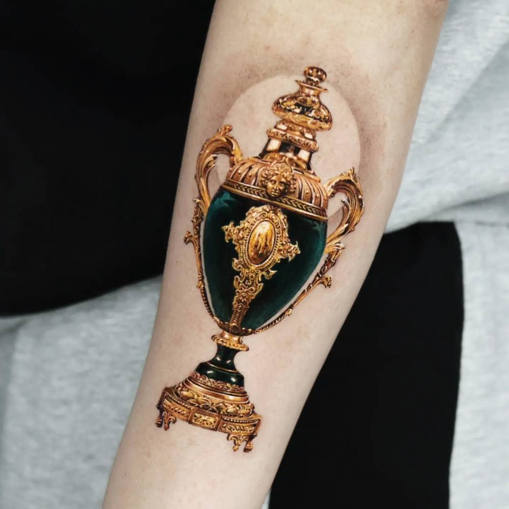 Micro-realistic style vase tattoo located on the forearm.