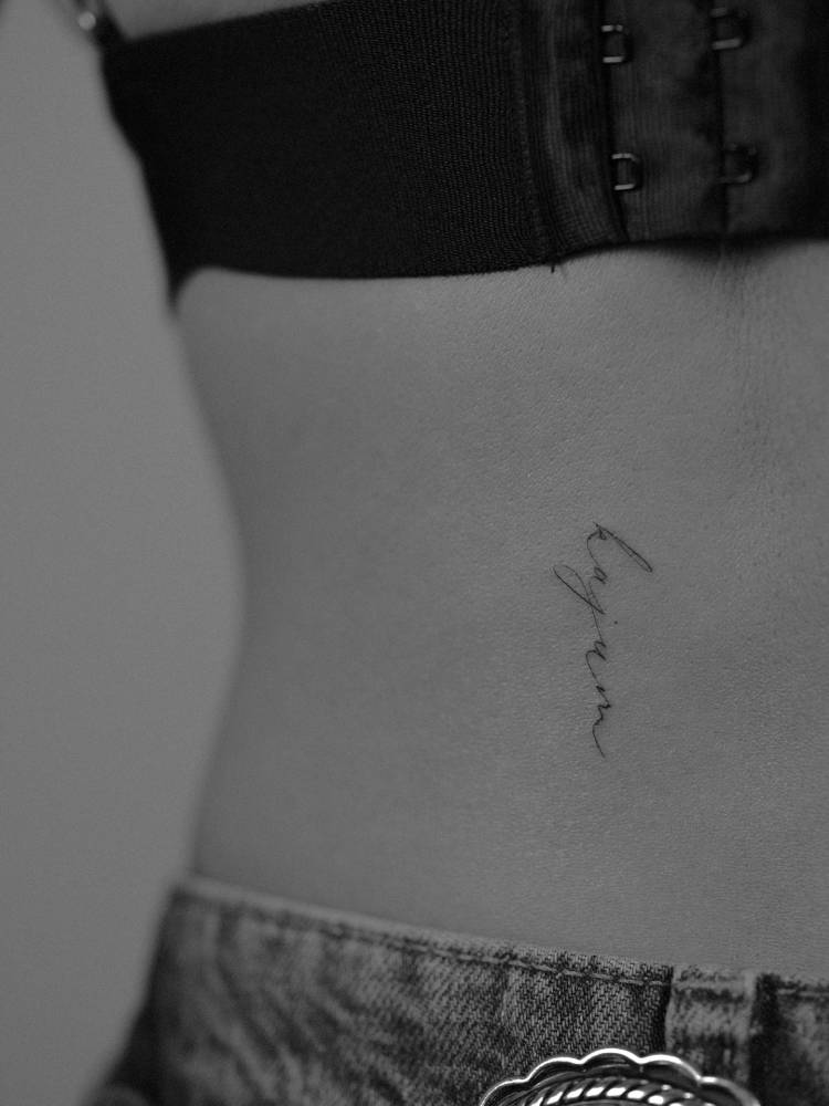 Her dog's name tattooed on the lower back.