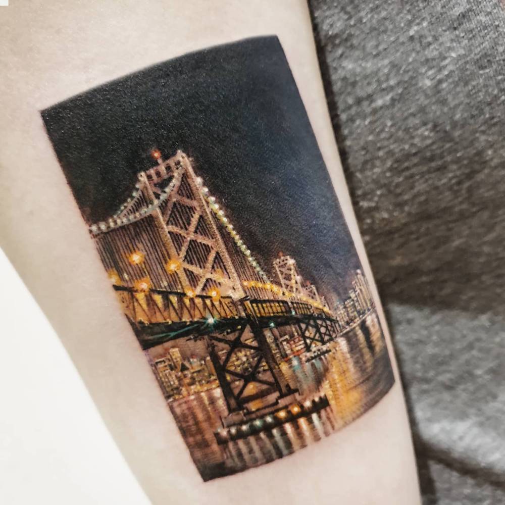 Oakland Bay Bridge tattoo in micro-realistic style.