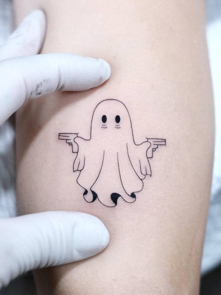 Cartoon style ghost tattoo located on the tricep.