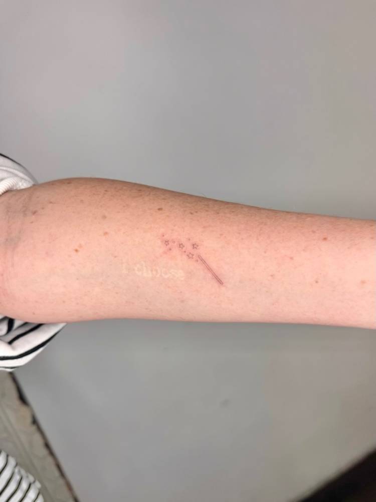 Single needle magic wand tattoo located on the inner forearm.