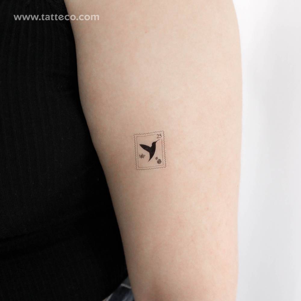 Hummingbird stamp temporary tattoo located on the upper arm.