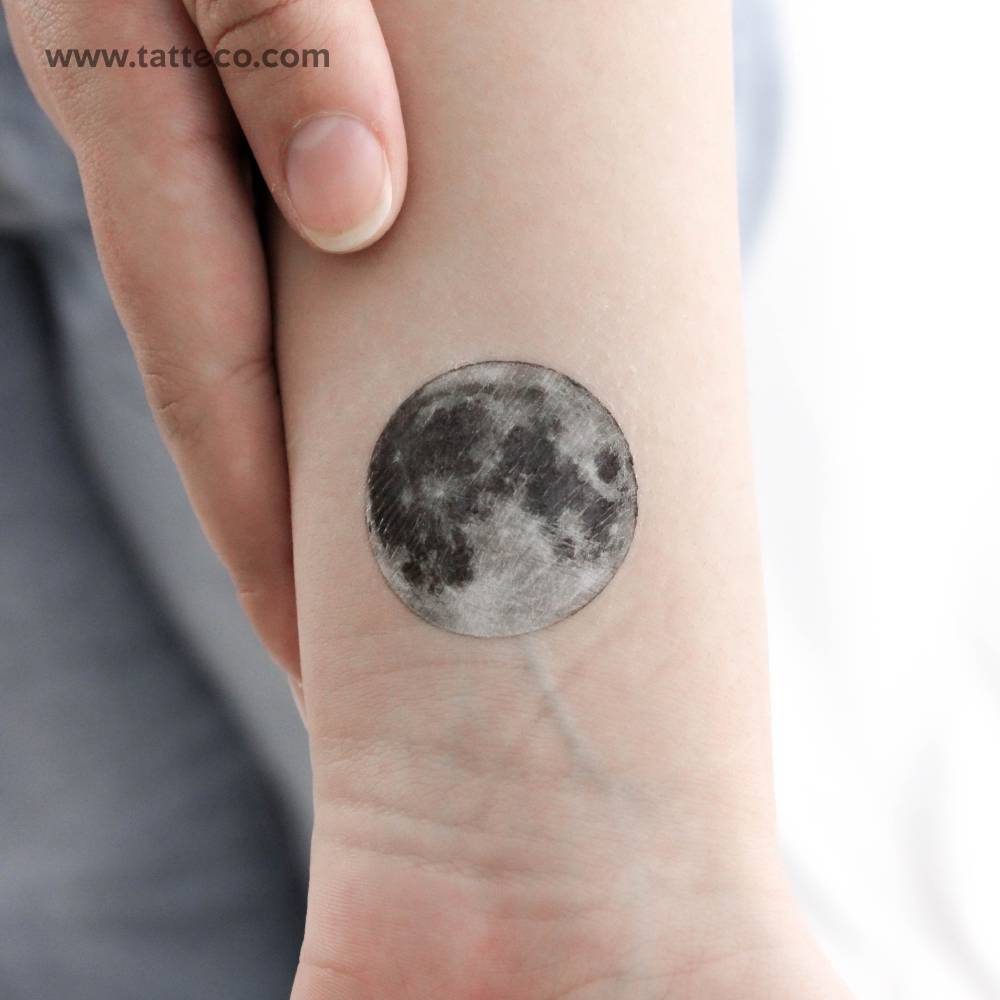 Realistic style full moon temporary tattoo located on the wrist.