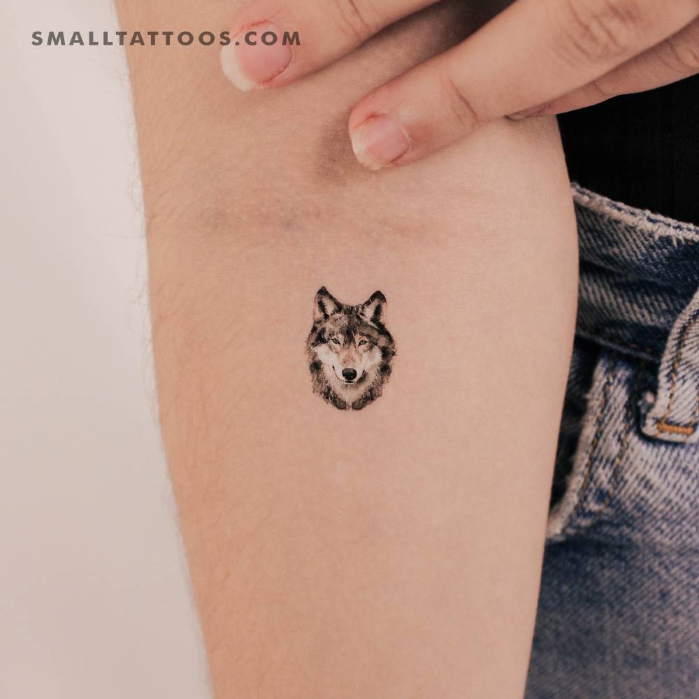 Wolf portrait temporary tattoo located on the inner forearm.