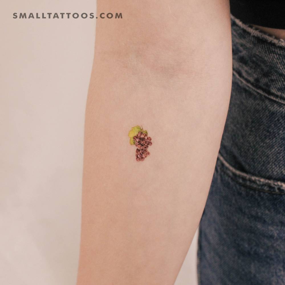 Watercolor style grapes temporary tattoo placed on the inner forearm.