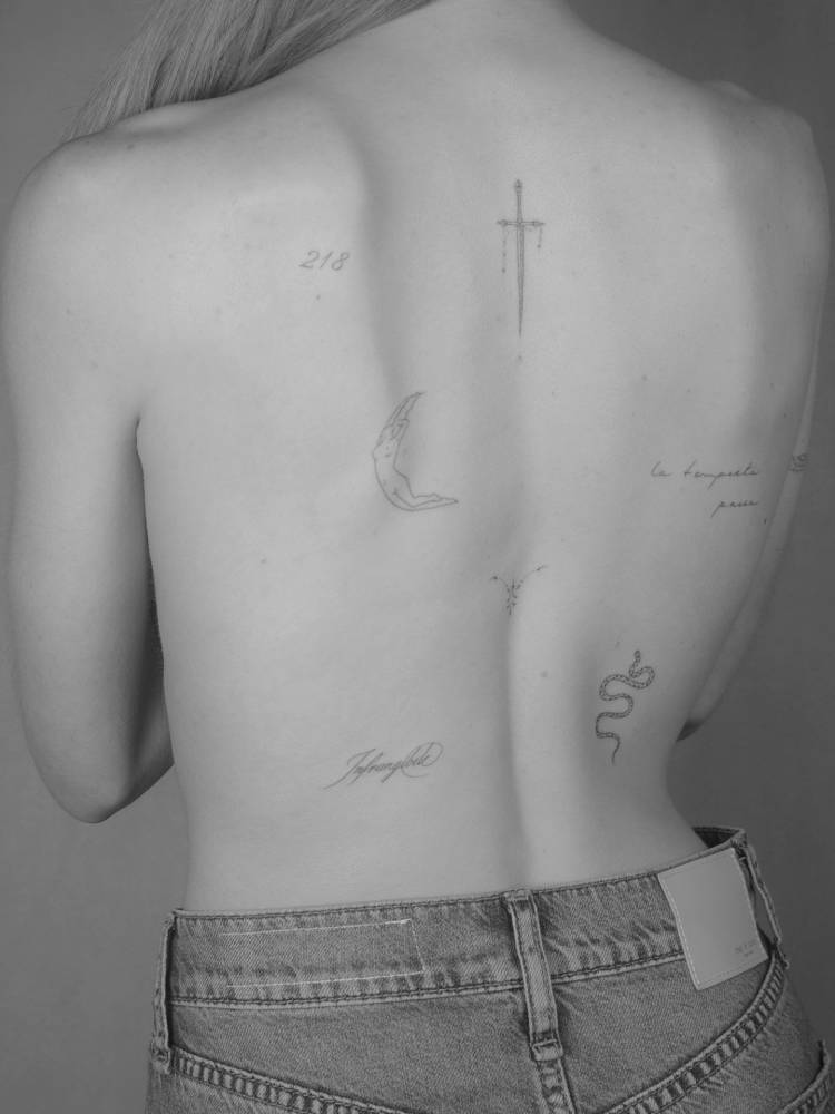 Back composition tattoos in fine line style.