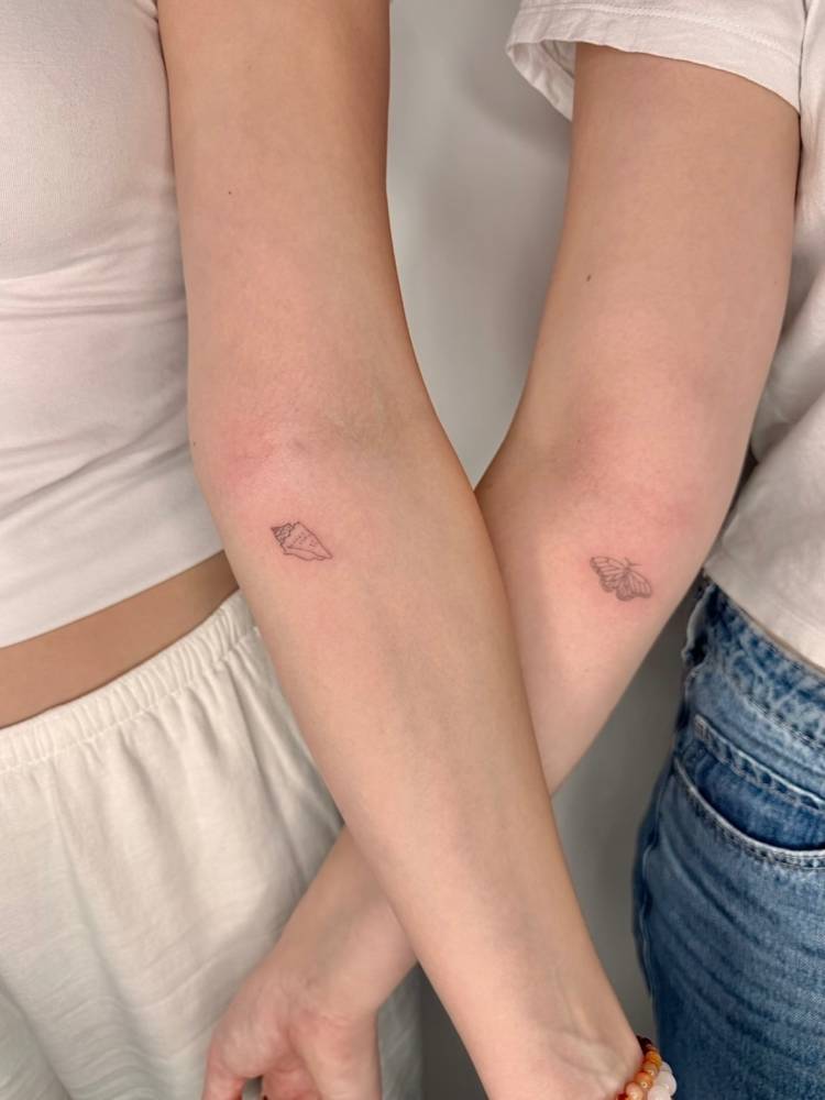 Tulip shell and butterfly tattoos in fine line style.