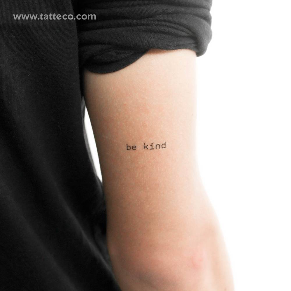 Typewriter font "be kind" temporary tattoo located on the tricep.