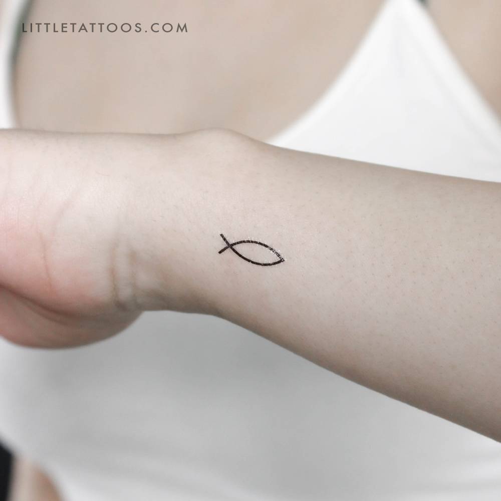 Minimalisti style Jesus Fish temporary tattoo placed on the wrist.