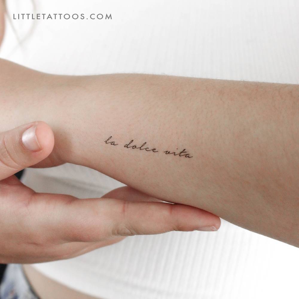 "La dolce vita" temporary lettering tattoo located on the wrist.