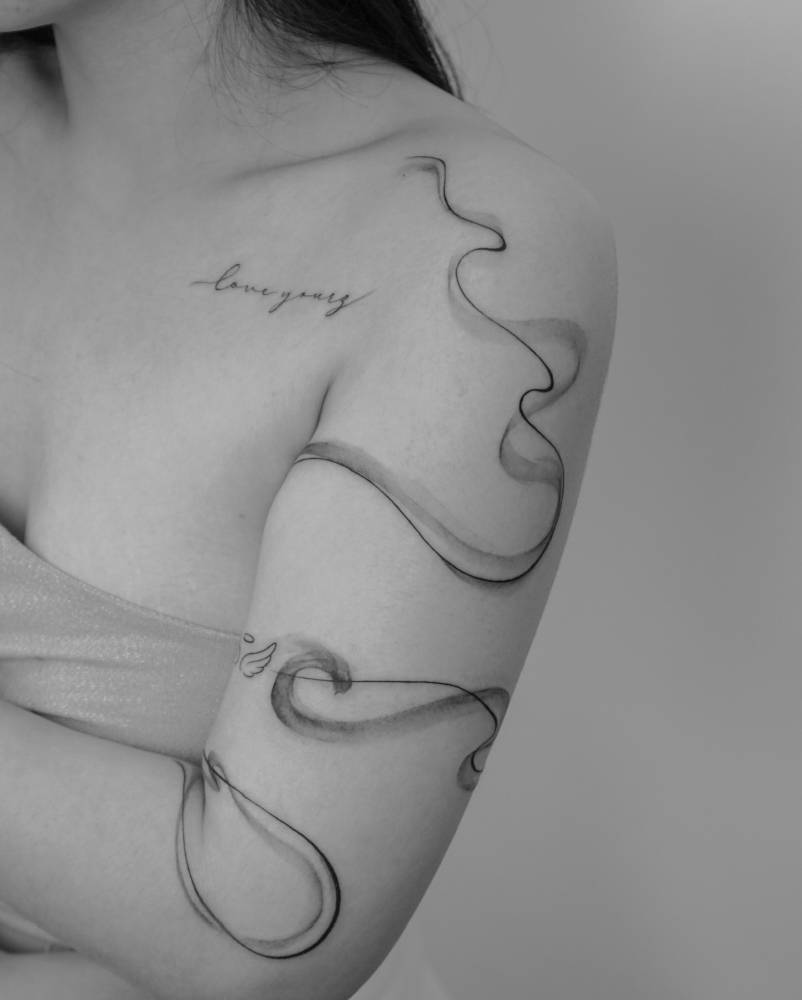 Abstract design tattooed on the upper arm.