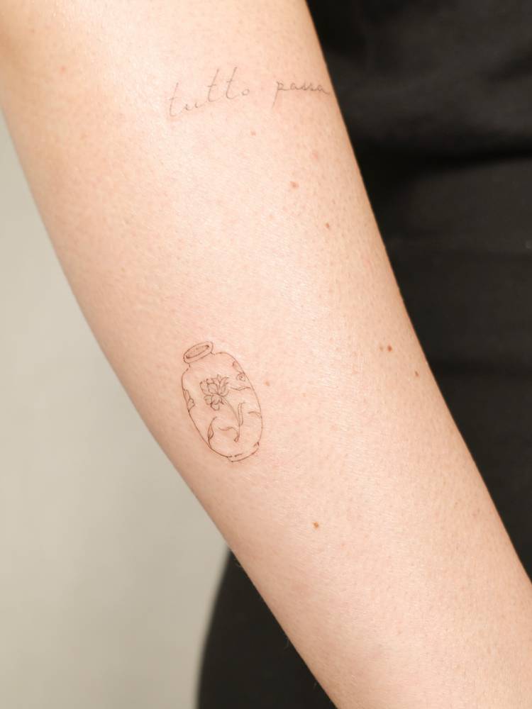 Vase tattoo located on the forearm, done in fine line style.