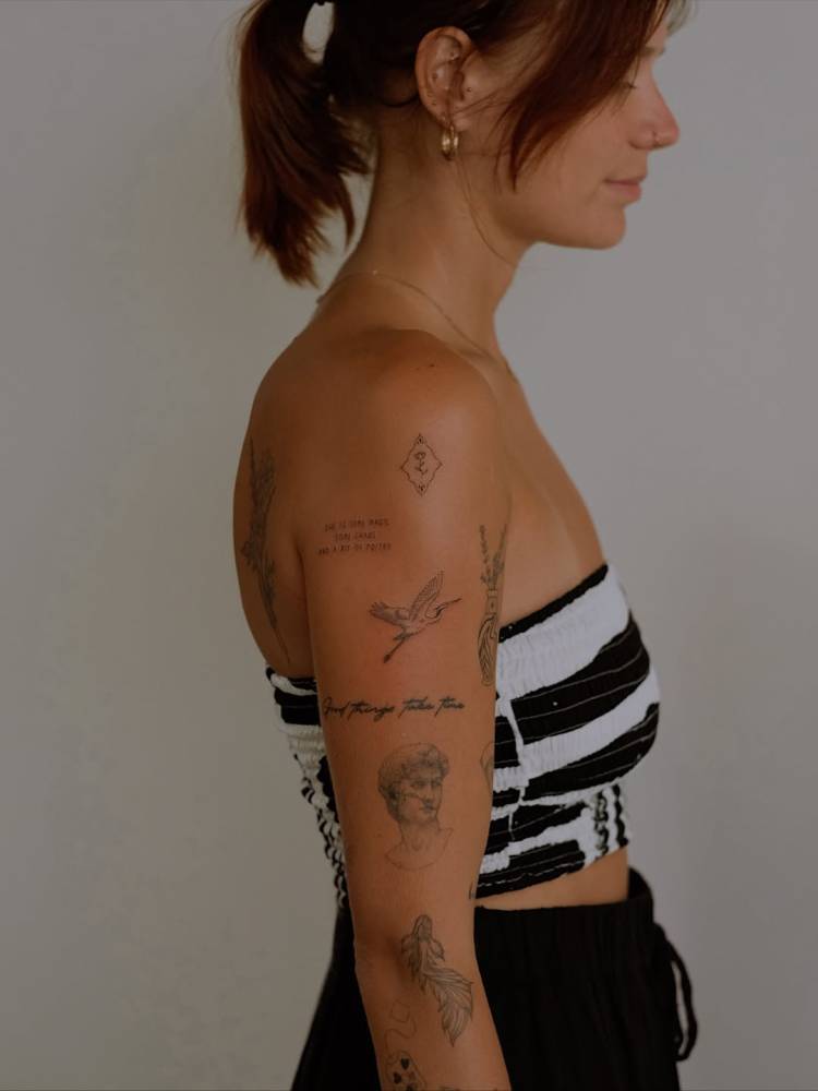 Upper arm composition tattoos.