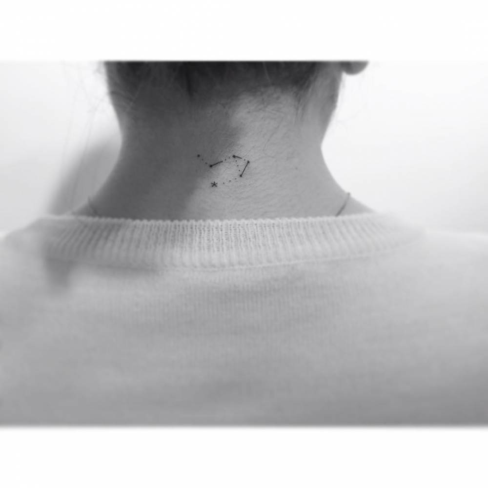 Libra constellation tattoo placed on the back of the neck.