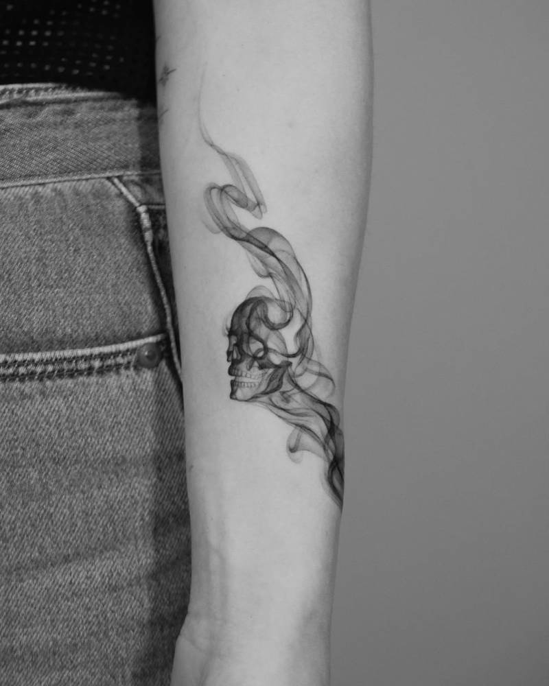 Abstract skull tattoo located on the inner forearm.