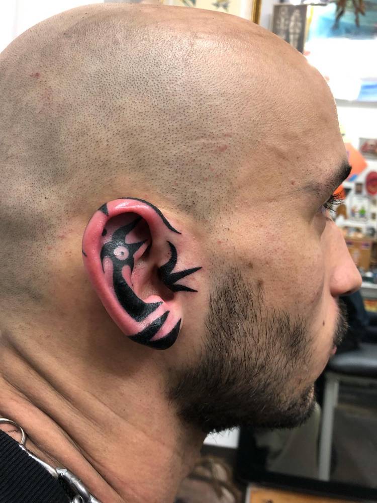 Tribal design tattooed on the ear.