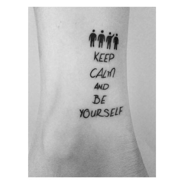 "Keep calm and be yourself" lettering tattoo located on the ankle.