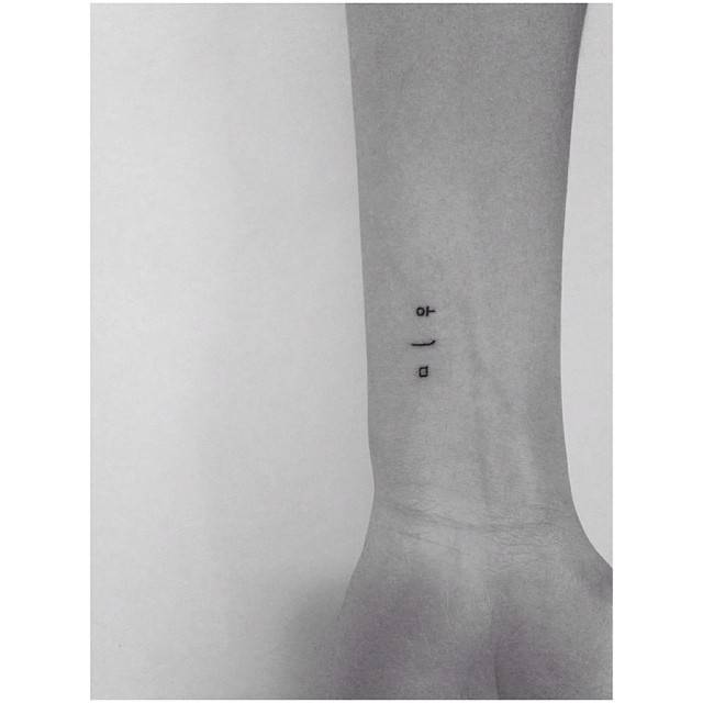Korean lettering tattoo located on the wrist.