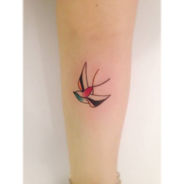 Illustrative style swallow tattoo located on the inner forearm.