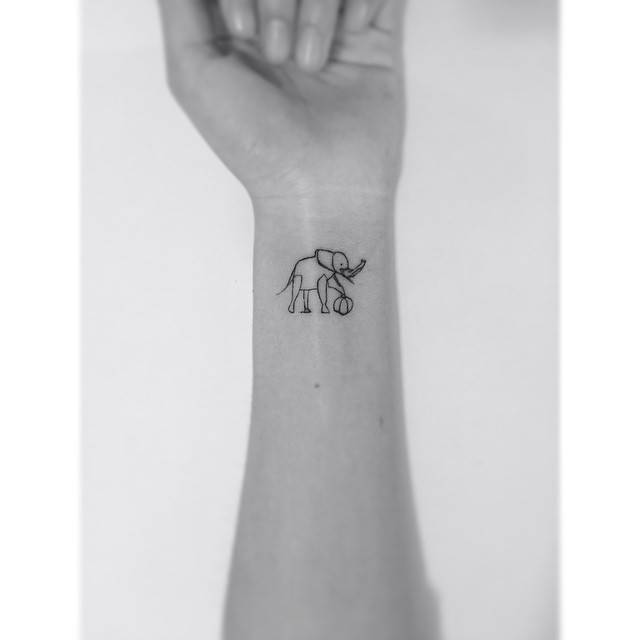 Elephant tattoo done in fine line style placed on the wrist.