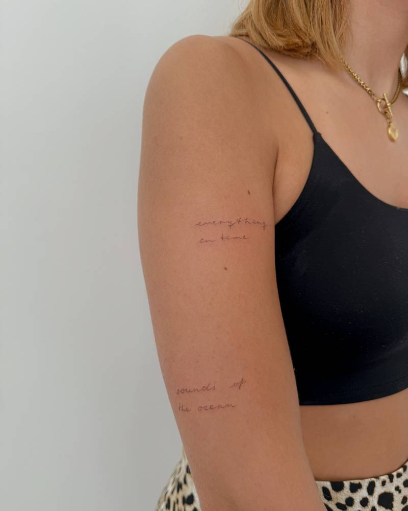 "Everything in time" and "sounds of the ocean" lettering tattoos.
