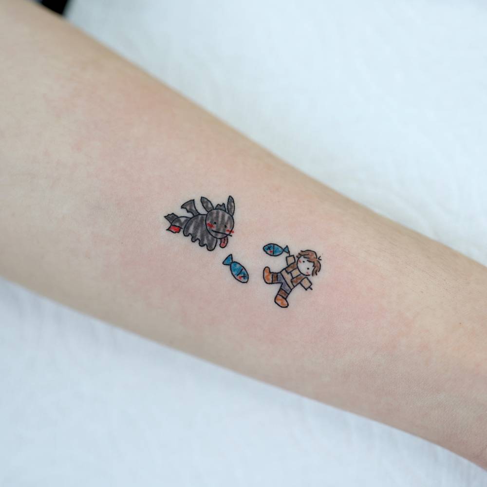 How to Train Your Dragon tattoo located on the inner forearm.