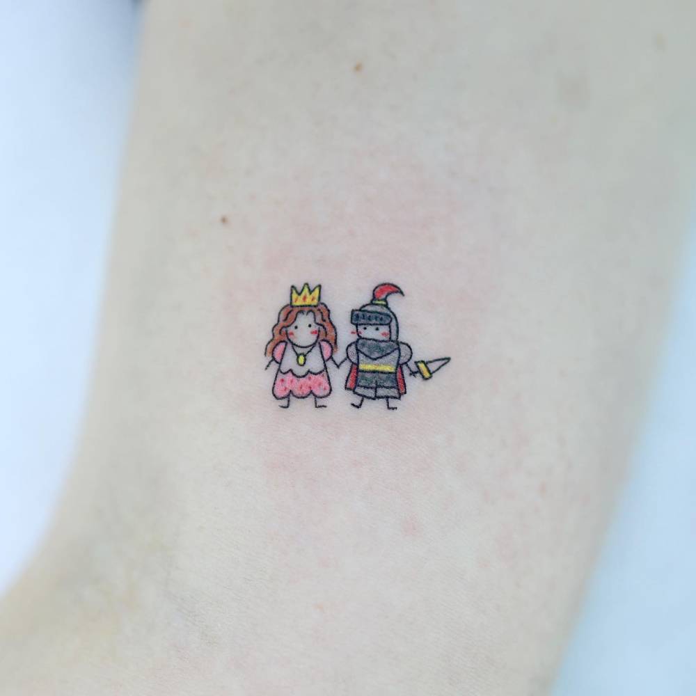 Tiny cartoon style princess and knight tattoo done on the inner arm.