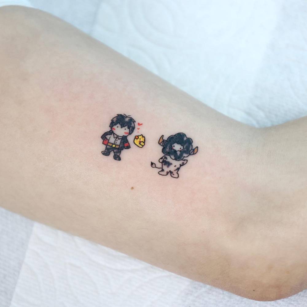 'Katekyō Hitman Reborn!' tattoo in cartoon style located on the inner arm.
