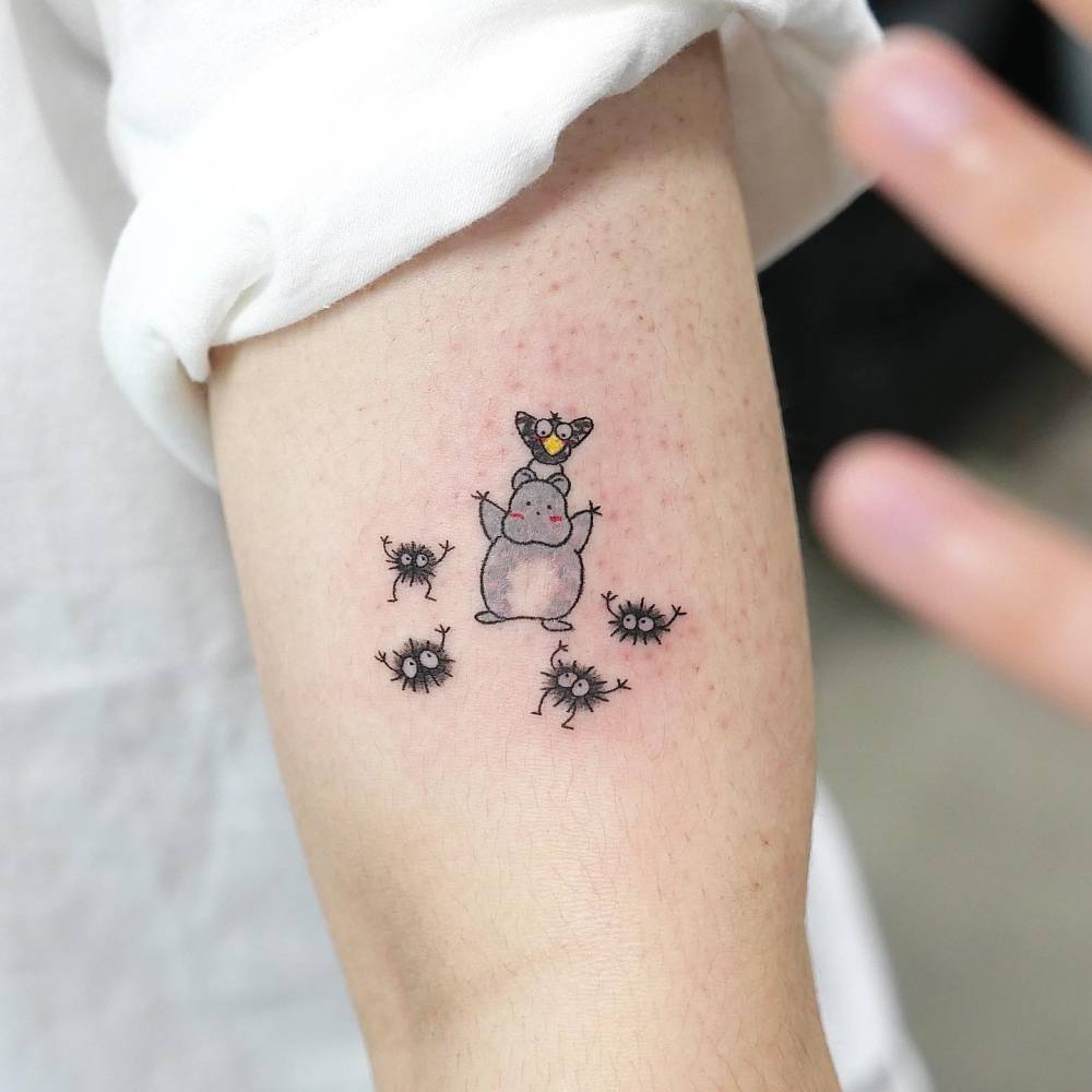 Spirited Away tattoo in cartoon style located on the upper arm.