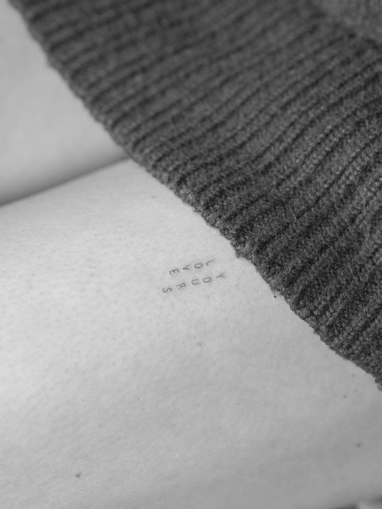 "Love yours" lettering tattoo placed on the thigh.