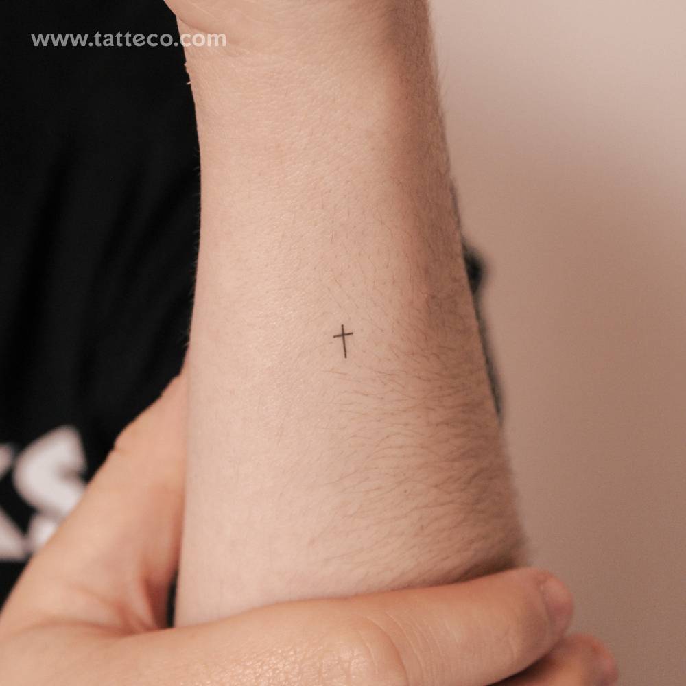 Tiny minimalist cross 2-week temporary tattoo.