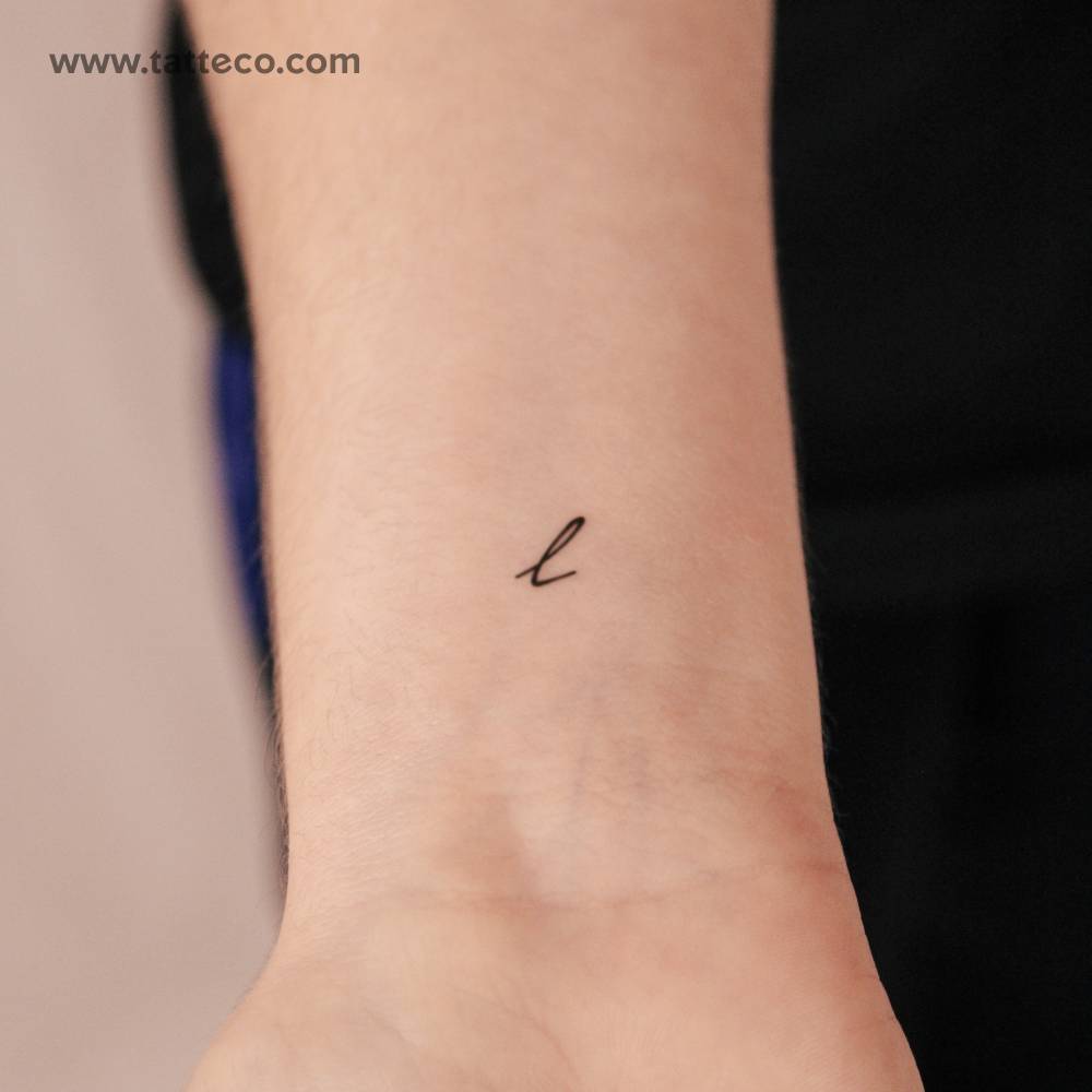 Small "L" handwritten letter semi-permanent tattoo.