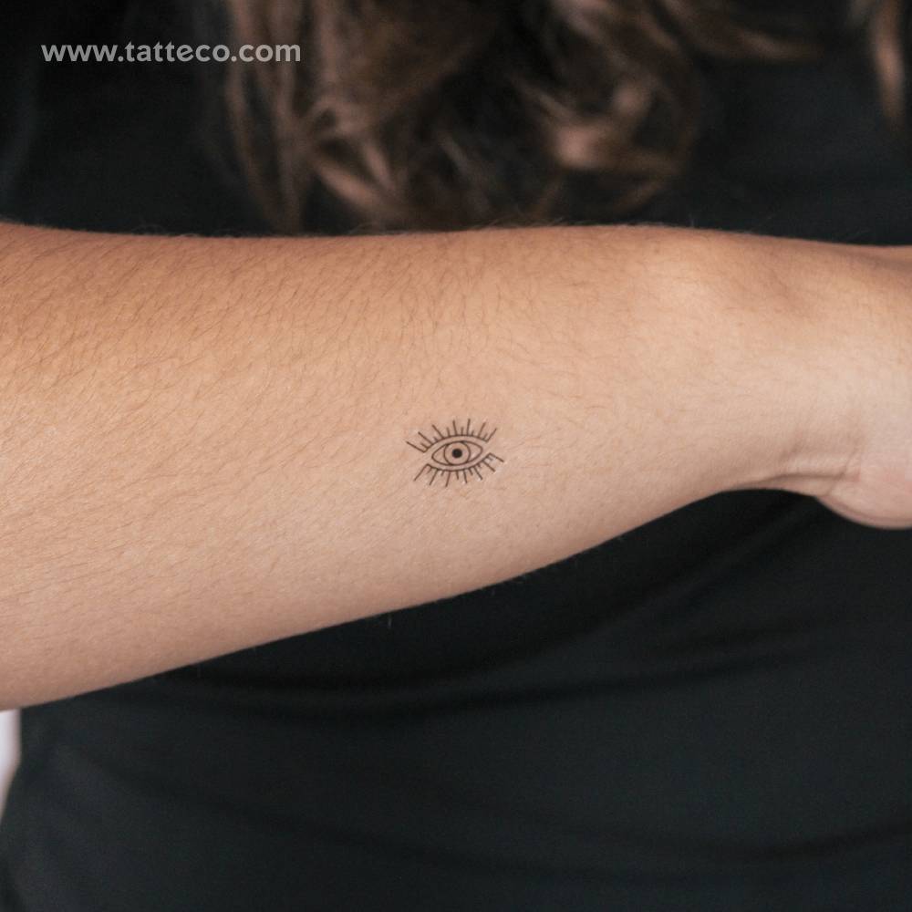 Minimalistic evil eye semi-permanent tattoo located on the wrist.