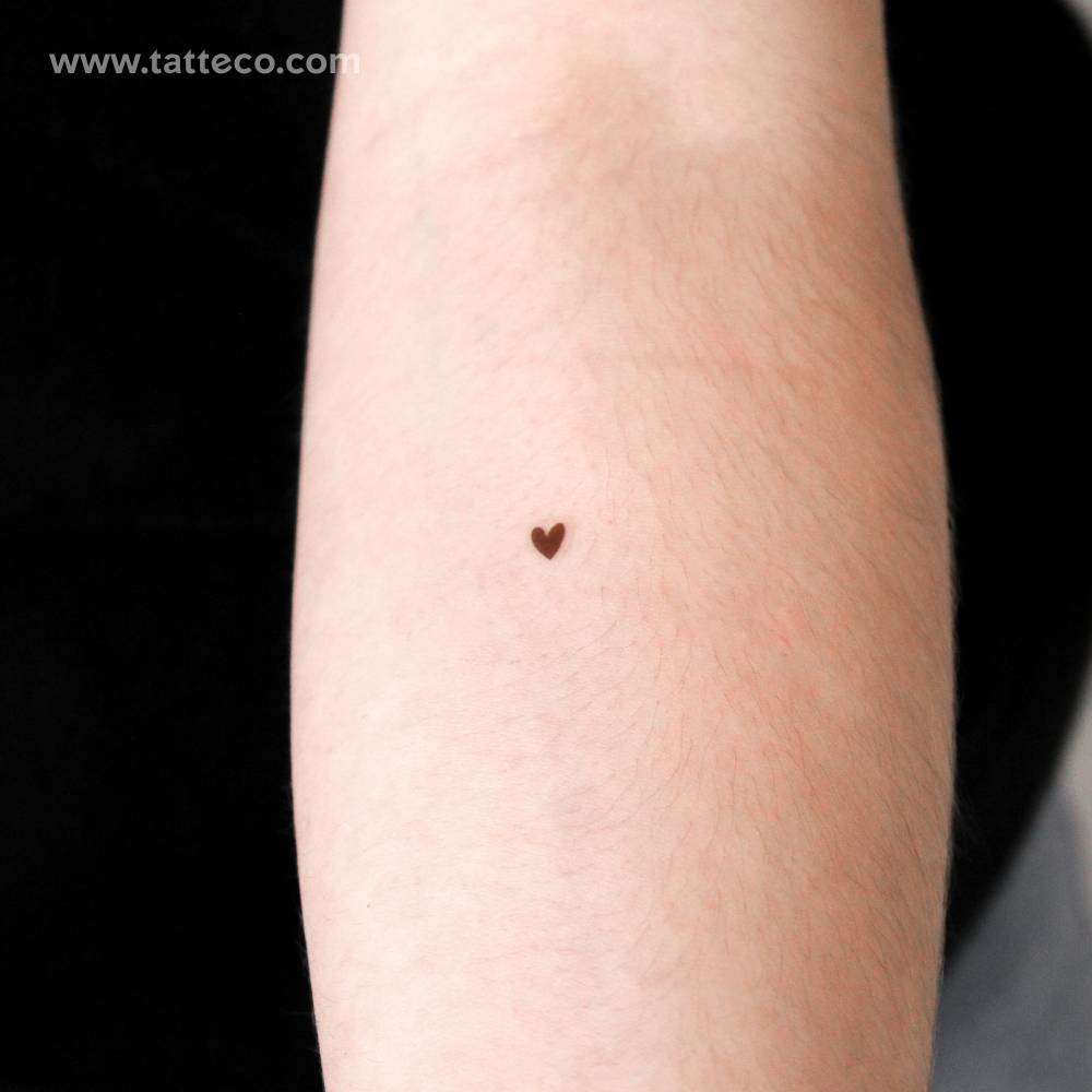 Hand-drawn brown heart temporary tattoo located on the inner forearm.