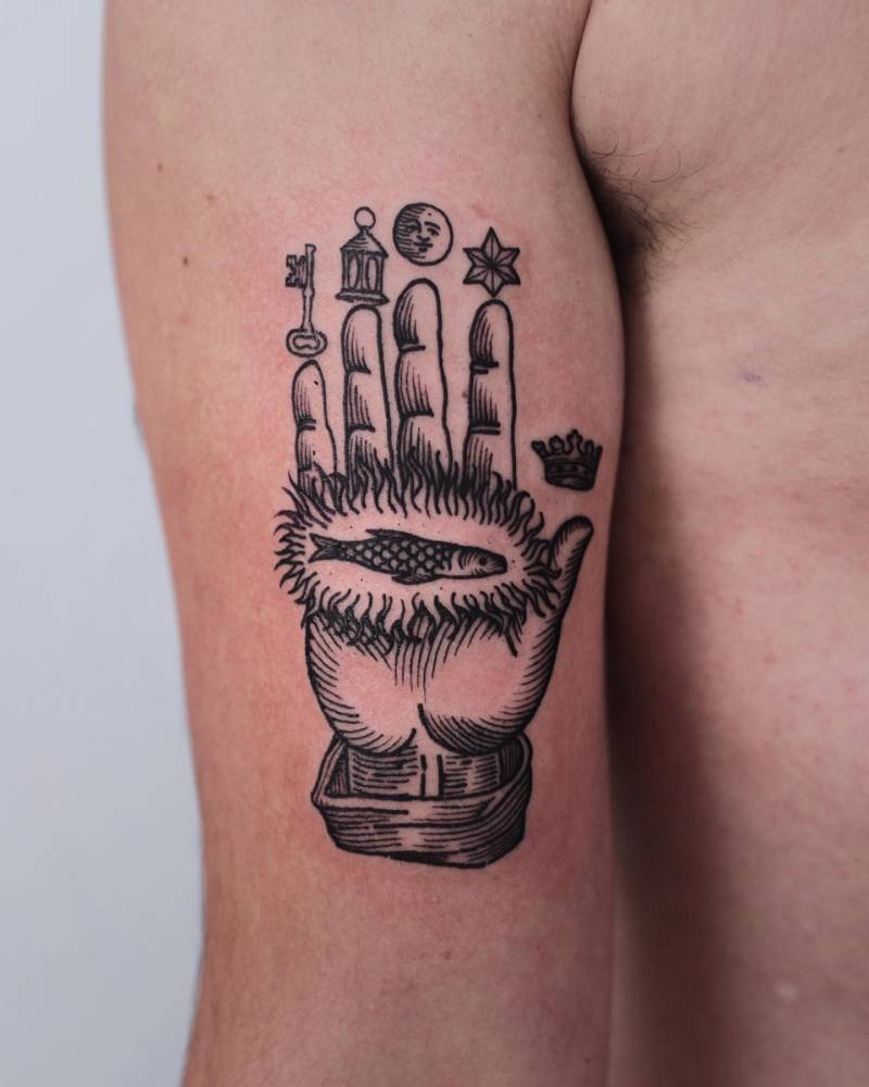 Philosopher's Hand tattoo located on the bicep, engraving style.